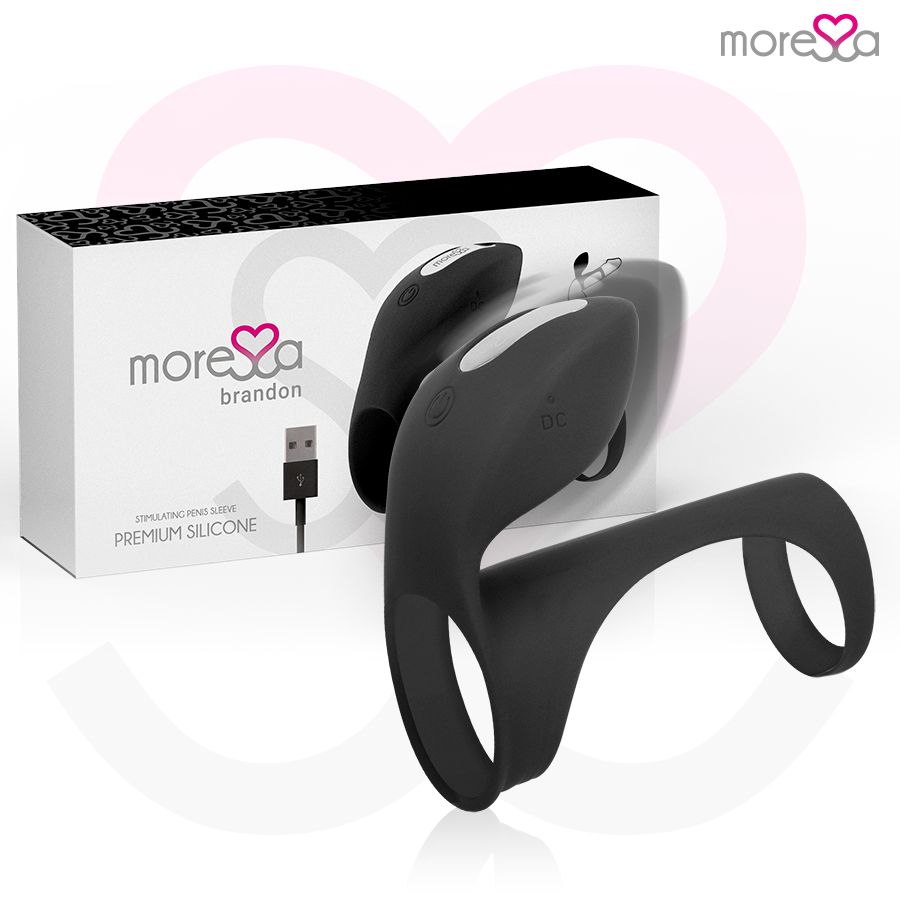 Anel Peniano Vibratório Moressa Brandon: Estimulador de casal em silicone preto com capa alongada e nervuras em relevo.