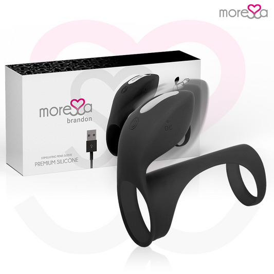 Anel Peniano Vibratório Moressa Brandon: Estimulador de casal em silicone preto com capa alongada e nervuras em relevo.