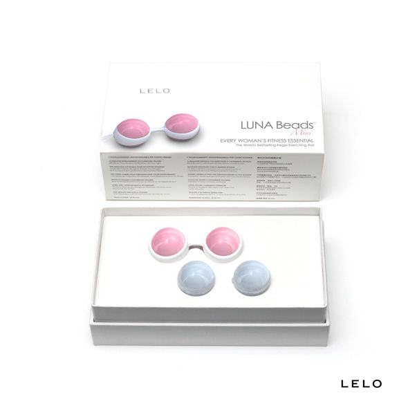 ELO Luna Sistema de Esferas de Kegel: Fotografia premium de estúdio com luz suave em fundo clean, exibindo o suporte de silicone rosa do LELO Luna ao lado das esferas modulares